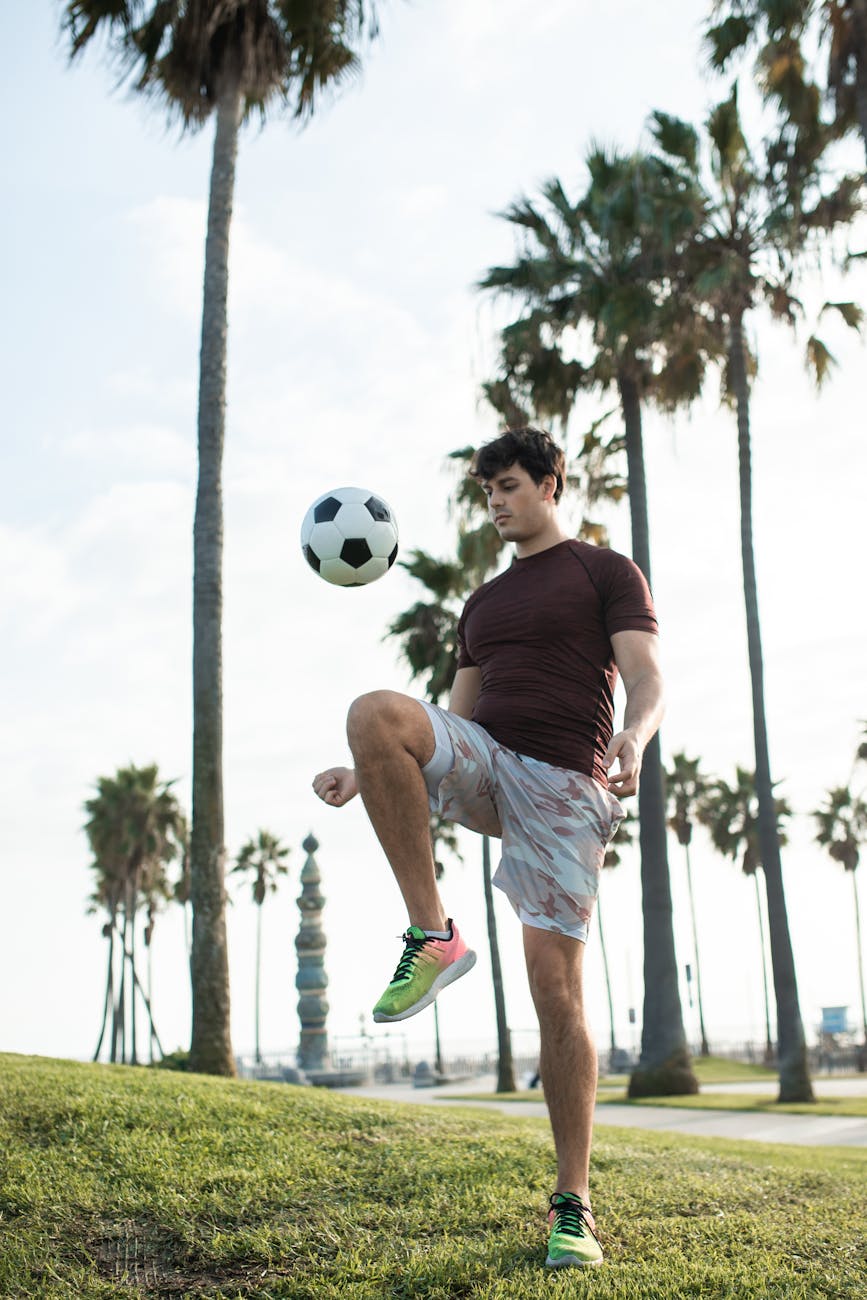 a man juggling a soccer ball with his knee
